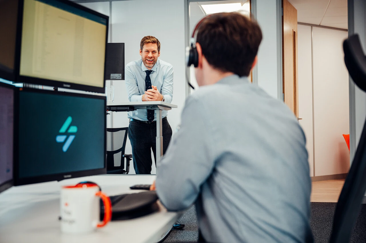 A photo of 2 IT engineers discussing a business's IT support needs.